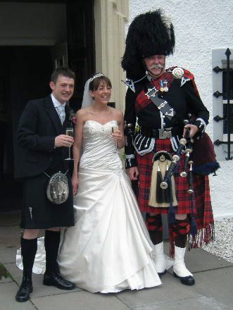 Lesleyanne and Jamie with Scottish Piper Jim Nicholl at the Barony Castle